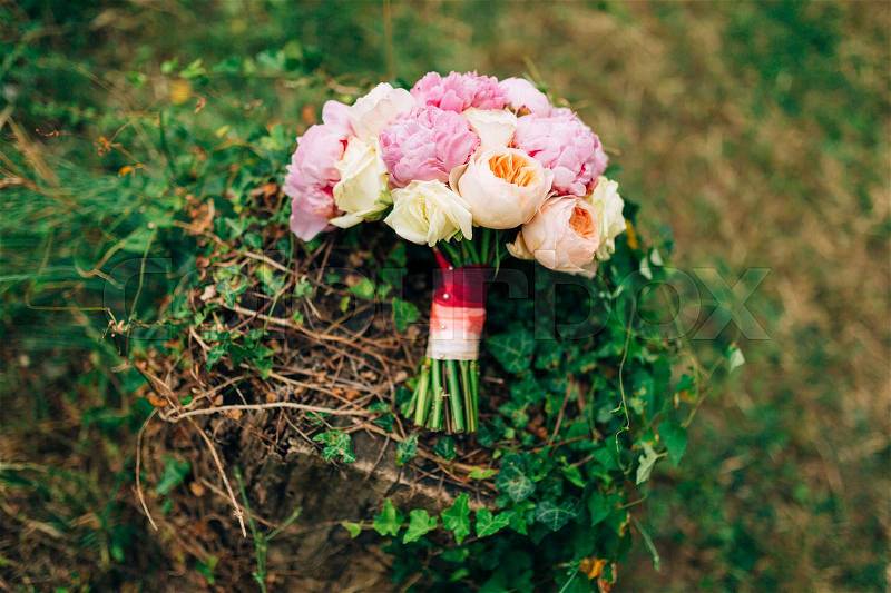 Wedding roses and peonies on a stump with ivy. Wedding in Montenegro, stock photo