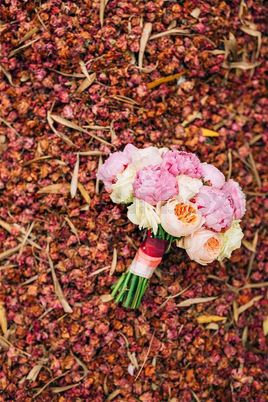 Wedding roses and peonies on dry red petals. Wedding in Montenegro, stock photo