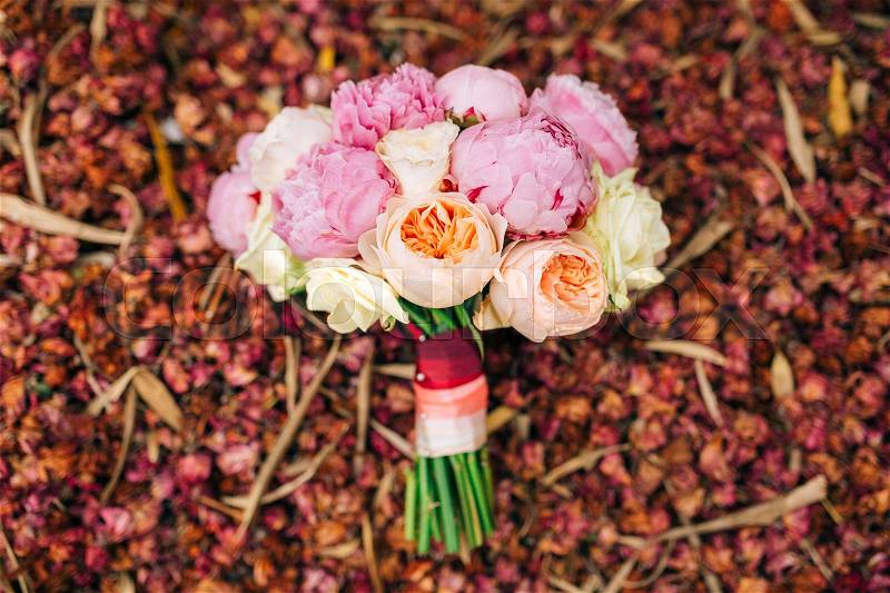 Wedding roses and peonies on dry red petals. Wedding in Montenegro, stock photo