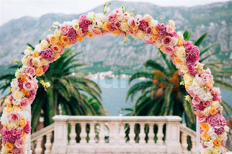 Wedding Arch of hydrangeas and roses. Wedding ceremony in the Bay of Kotor, in Montenegro, in the territory of the church of the Nativity of the Virgin in Prcanj, stock photo