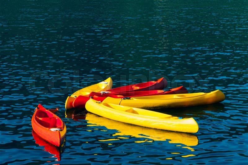 Kayaks moored in the water. Empty kayaks without people. In the Bay of Kotor, in Montenegro, stock photo