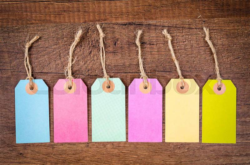 Set of colorful blank hang tag on wooden background. Ready for your text. , stock photo