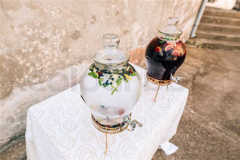 Lemonade in a glass barrel. Flasks for spilling drinks. Lemonade glass jars at the wedding reception. An adorable summer lemonade stand, stock photo