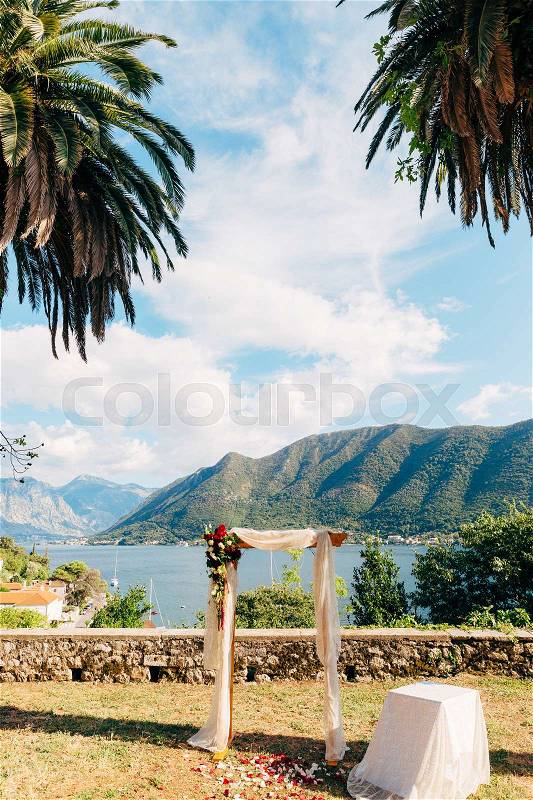 Wedding ceremony at a church Orthodox Church of the Nativity of the Virgin in Perast between the palm trees in Montenegro, stock photo