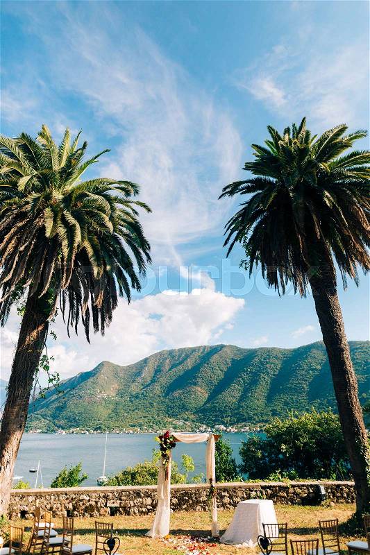 Wedding ceremony at a church Orthodox Church of the Nativity of the Virgin in Perast between the palm trees in Montenegro, stock photo