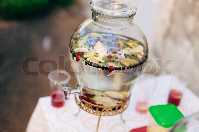 Lemonade in a glass barrel. Flasks for spilling drinks. Lemonade glass jars at the wedding reception. An adorable summer lemonade stand, stock photo