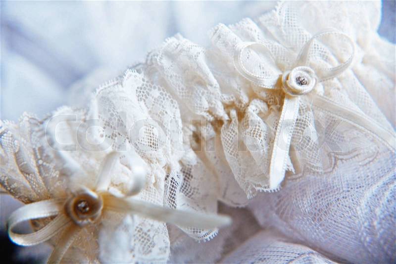 Lace wedding garter partly out of focus horizontal, stock photo