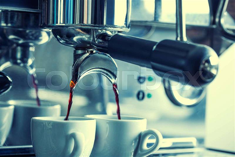 Coffee.Two cups with fresh espresso in coffee maker, stock photo