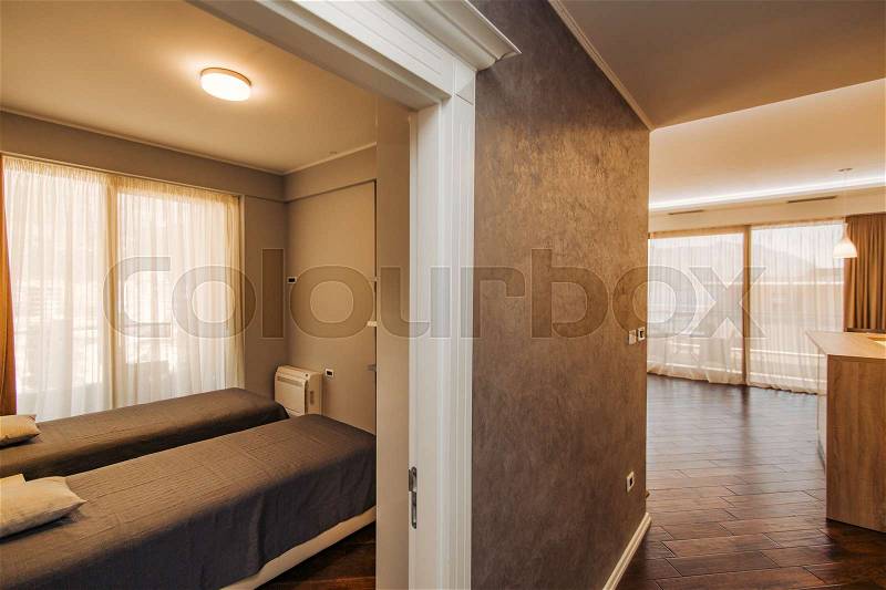 The bedroom in the apartment. Bed, wardrobe, bedside tables in the bedroom of the apartment, stock photo