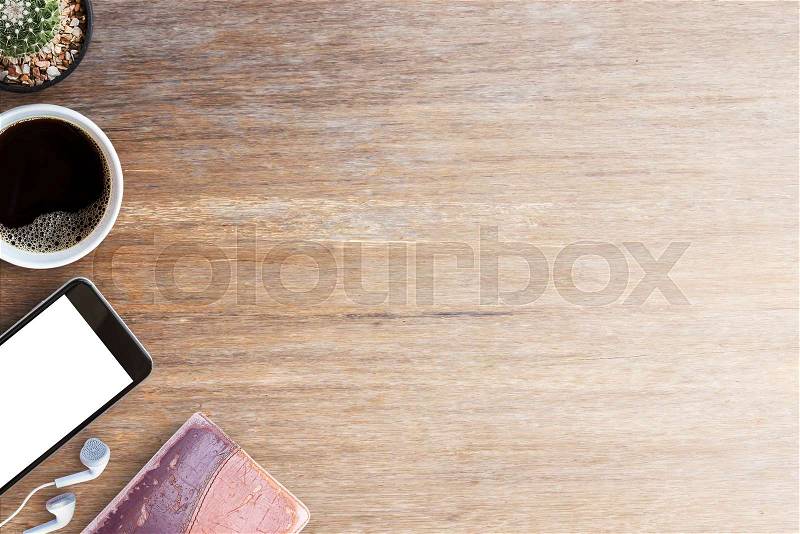Smart phone,old notebooks and earphone with cup of coffee on wood table. Top view with space for any design.Business concept, stock photo