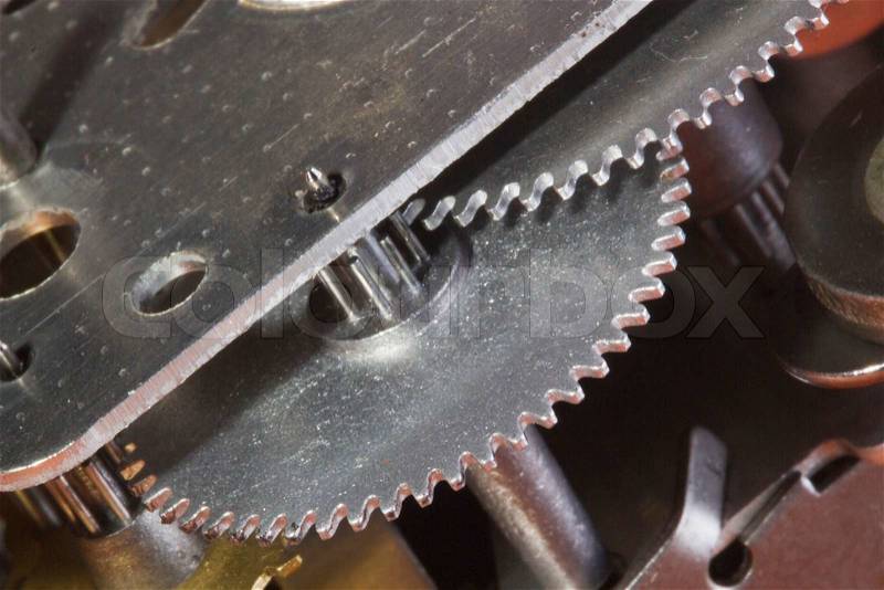 Close-up photograph of a silver gear mechanism, stock photo