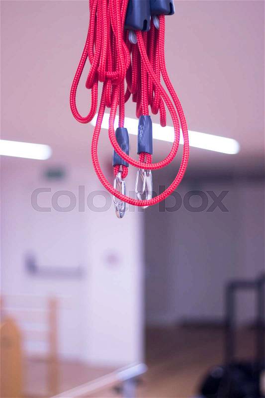 Yoga and pilates studio gym with red cord training equipment for exercise, rehabilitation, physical therapy and workout, stock photo