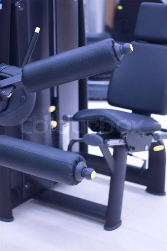 Leg weights extension for quadriceps and curl for hamstrings gym machine resistance workout equiment, stock photo