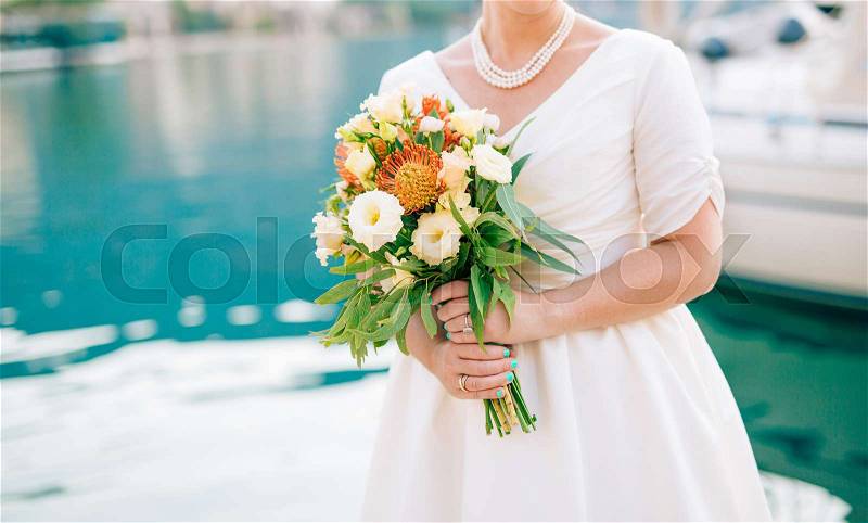 Wedding bridal bouquet of Proteus, Verdure Italian , Lisianthus in the hands of the bride. Wedding in Montenegro, Adriatic, stock photo