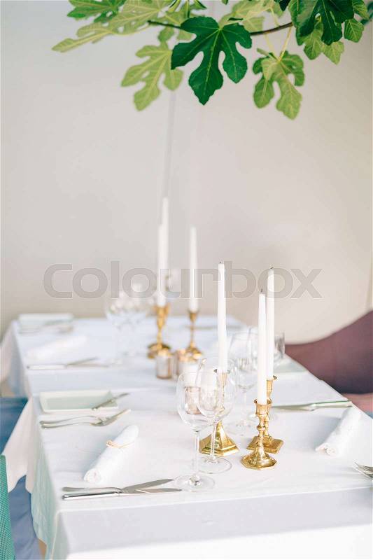Candles on the table in the restaurant. Table setting in a cafe. Romantic dinner, stock photo