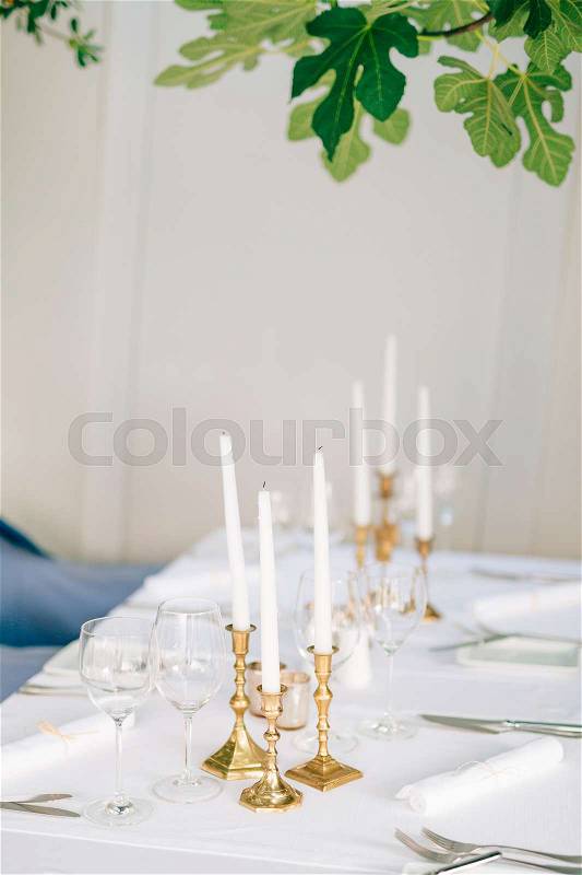 Candles on the table in the restaurant. Table setting in a cafe. Romantic dinner, stock photo