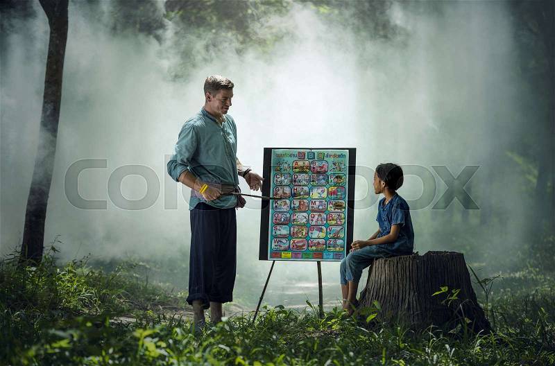 Foreign teachers teach students in rural Thailand, stock photo
