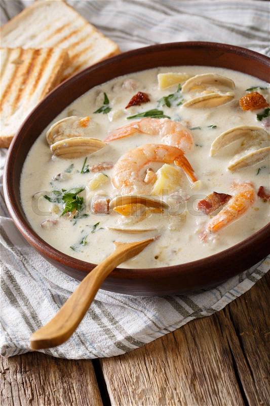 New England clam chowder soup close-up on the table. vertical , stock photo