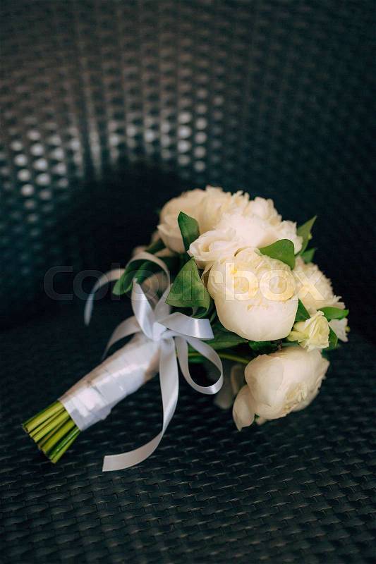 Wedding roses and peonies on a wicker chair. Wedding in Montenegro, stock photo