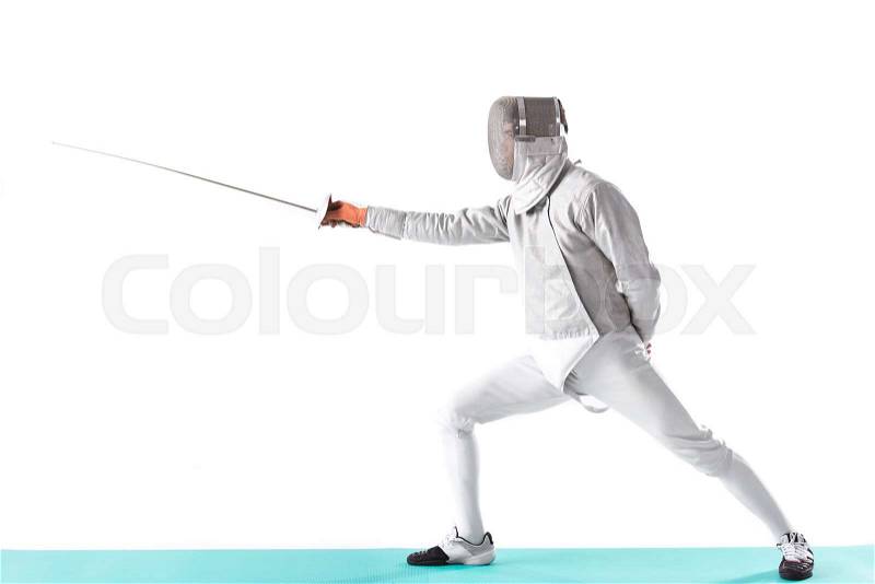 Side view of fencer in uniform trainign with rapier in hand on white, stock photo