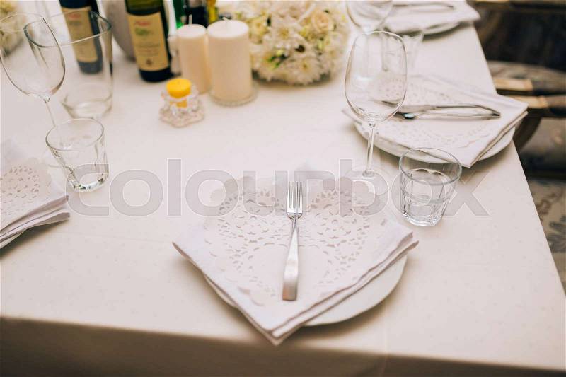Plates at the wedding banquet. Table setting. Wedding decorations. Wedding at the sea in Montenegro, stock photo