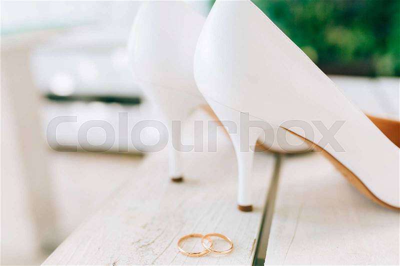 Wedding rings and wedding shoes bride. Wedding jewelry, stock photo