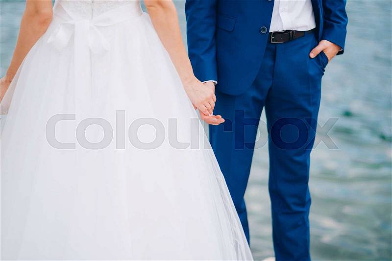 Bride and groom holding hands. Wedding in Montenegro, stock photo