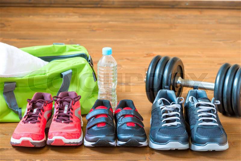 Sneakers for the whole family for sports on the wooden floor, stock photo
