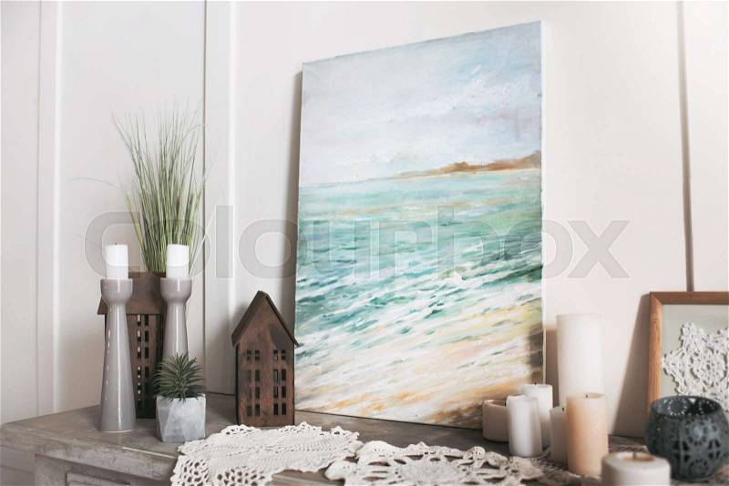 Picture of sea, candles and decorations standing on the shelf at home, stock photo
