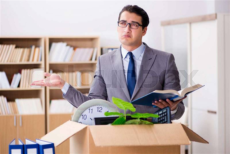 Young businessman moving offices after being made redundant, stock photo