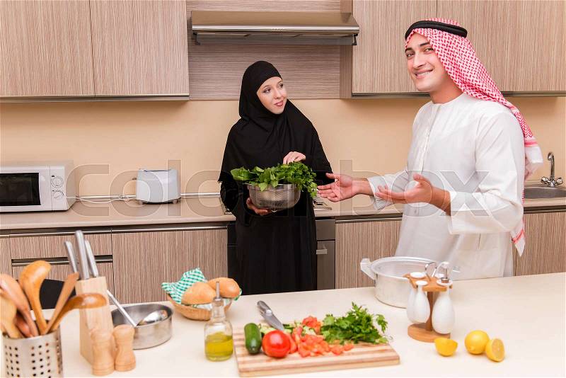 Young arab family in the kitchen, stock photo