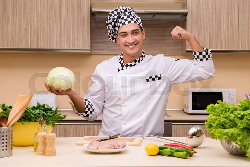 Young chef working in the kitchen, stock photo