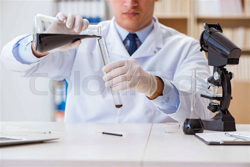 Chemical engineer working on oil samples in lab, stock photo