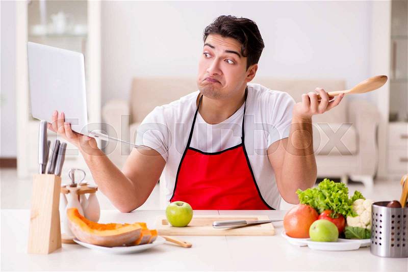 Funny man cook working in the kitchen, stock photo