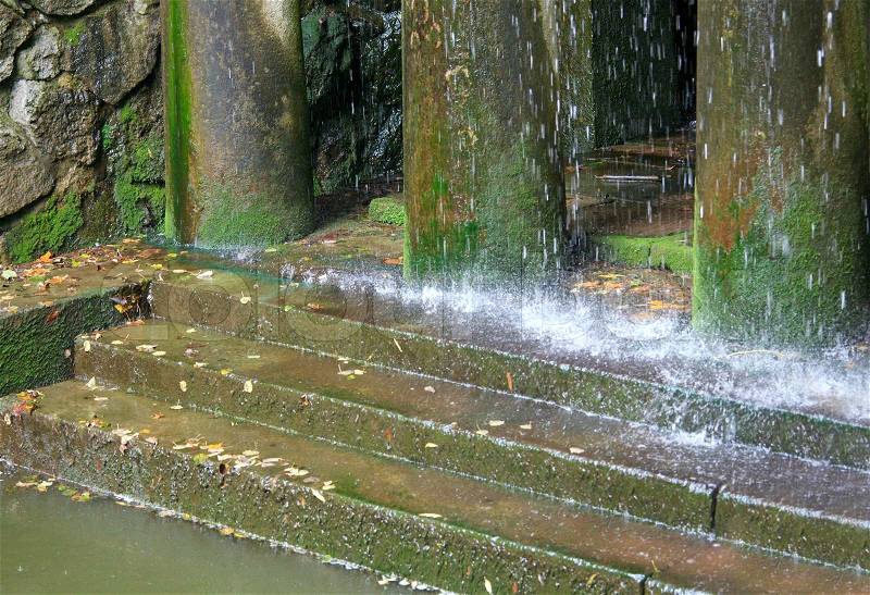 Rain and porch with pillars and steps (waterfall composition in old city park), stock photo