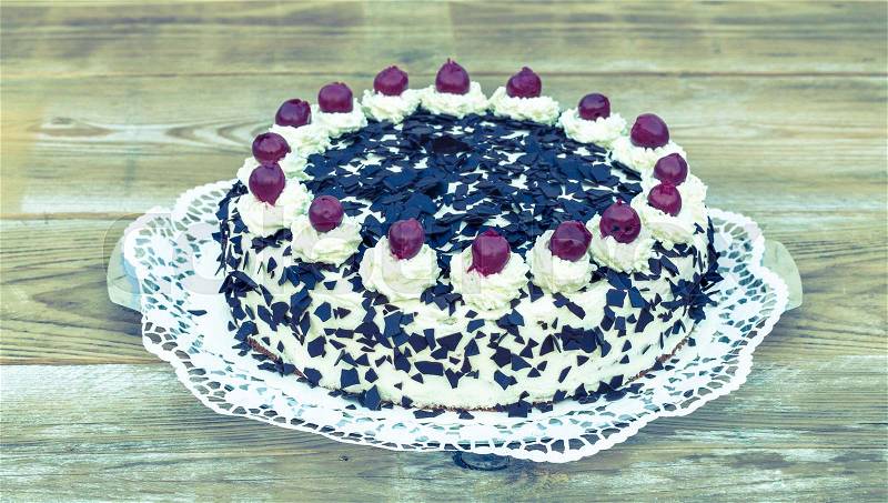 Black Forest cake on rustic wood, stock photo