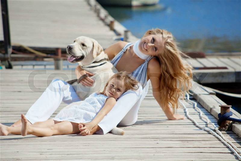 Happy family with dog on berth in summer, stock photo