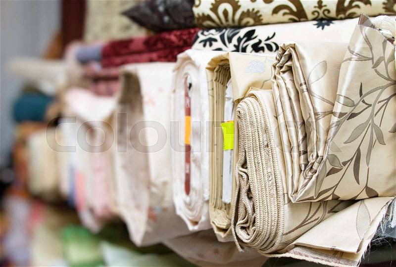 Fabric tubes Textile rolls in the Fabric Shop, stock photo