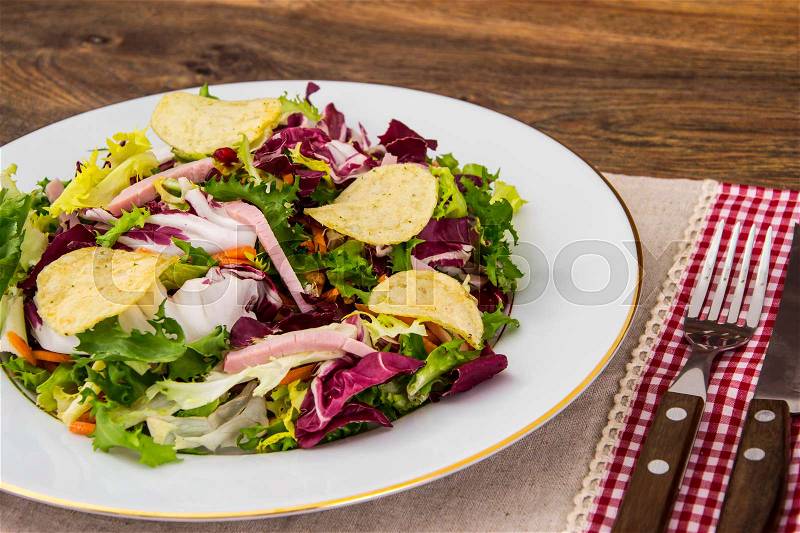 Fresh salad mix with ham and chips. Studio Photo, stock photo