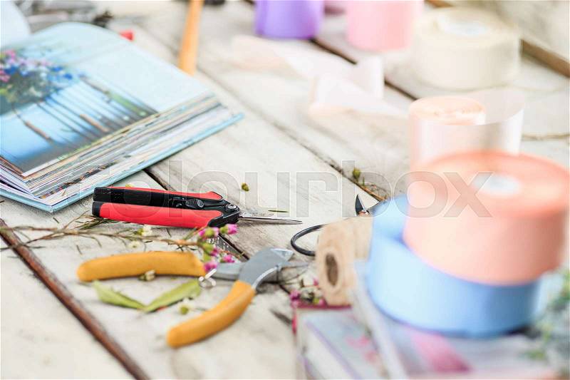 The florist desktop with working tools on white wooden background, stock photo