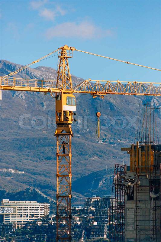 Construction of a multi-storey building. The crane is working. Budva, Montenegro, stock photo