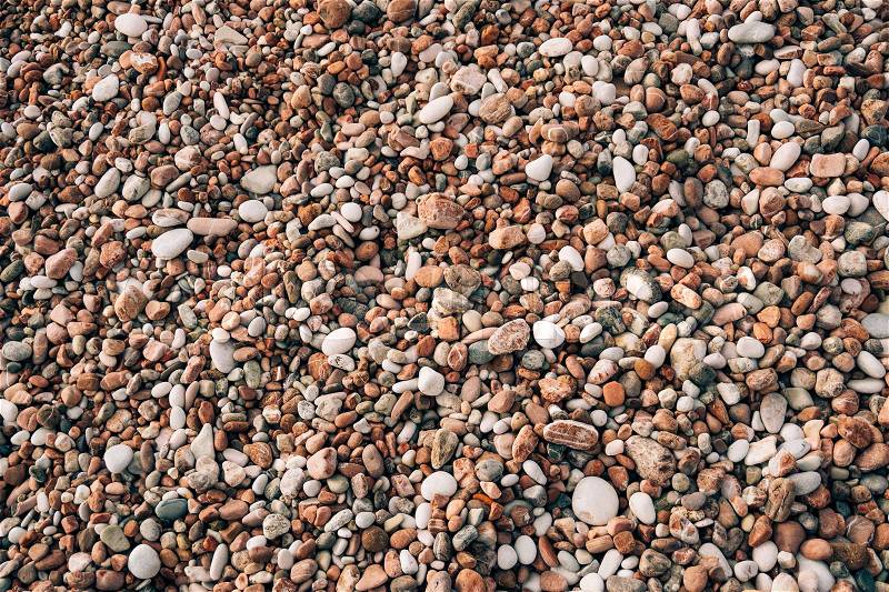 Pebbles on the beach. Texture of the sea shore. The Adriatic Sea in Montenegro, stock photo