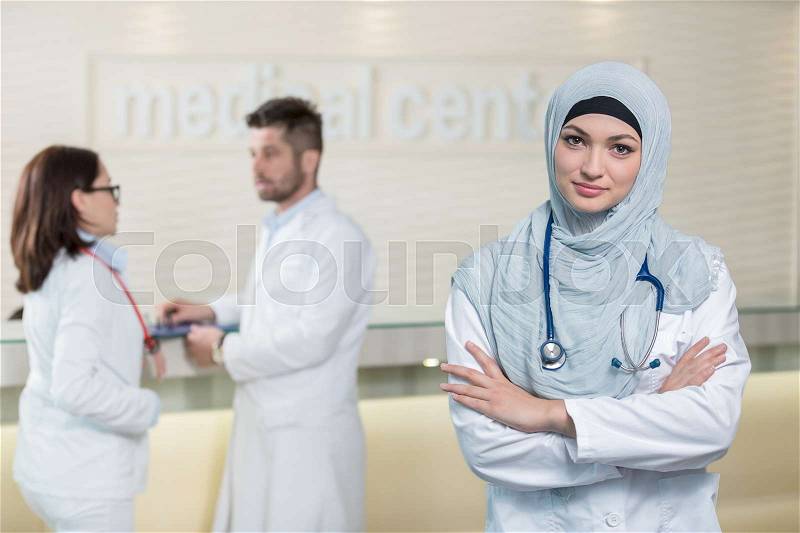 Medical team in different races standing indoor, stock photo