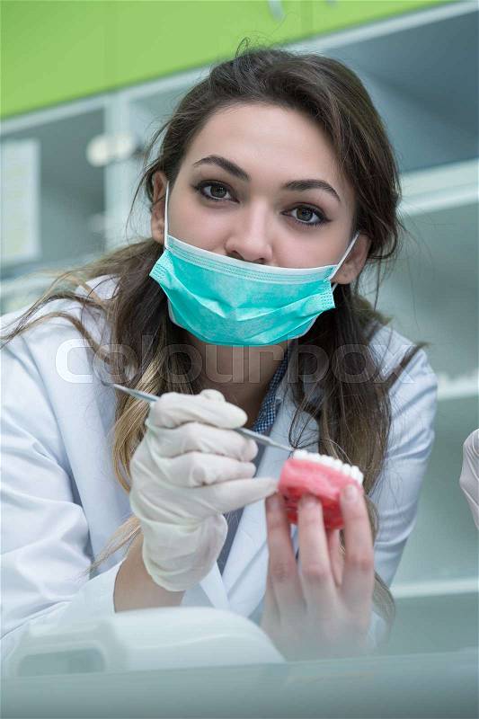 Young female dental student first time in clinic, stock photo