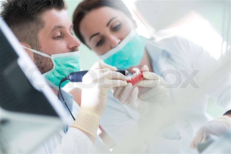 Closeup of dentistry student practicing on a medical mannequin, stock photo