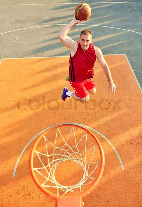 View of flying ball to basket from top. Face gesture, stock photo