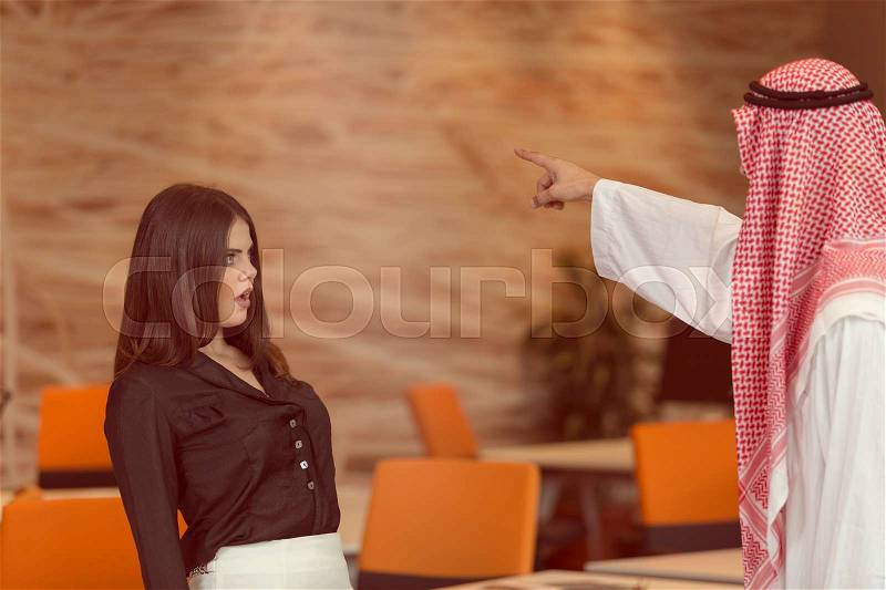 Woman office worker gets fired by arab businessman, stock photo