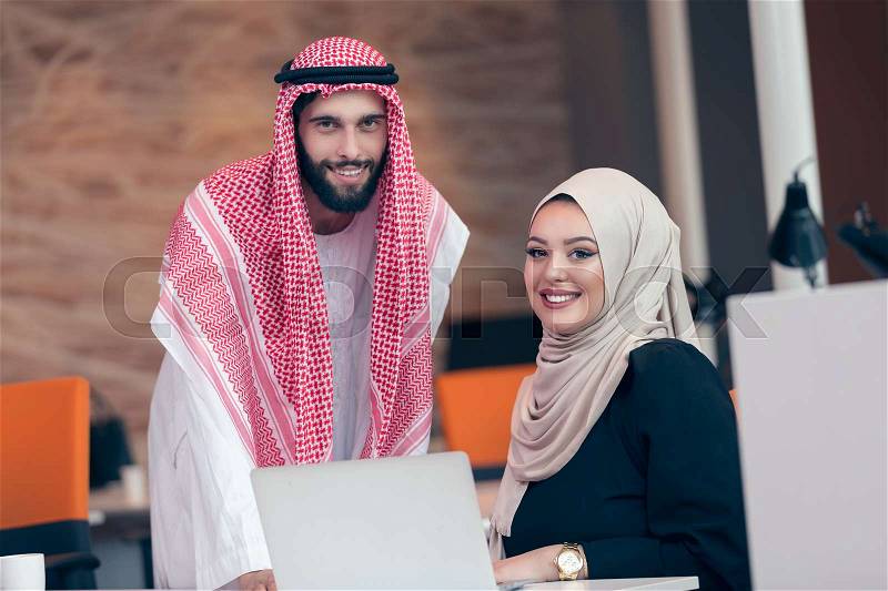 Arabic business couple working together on project at modern startup office, stock photo