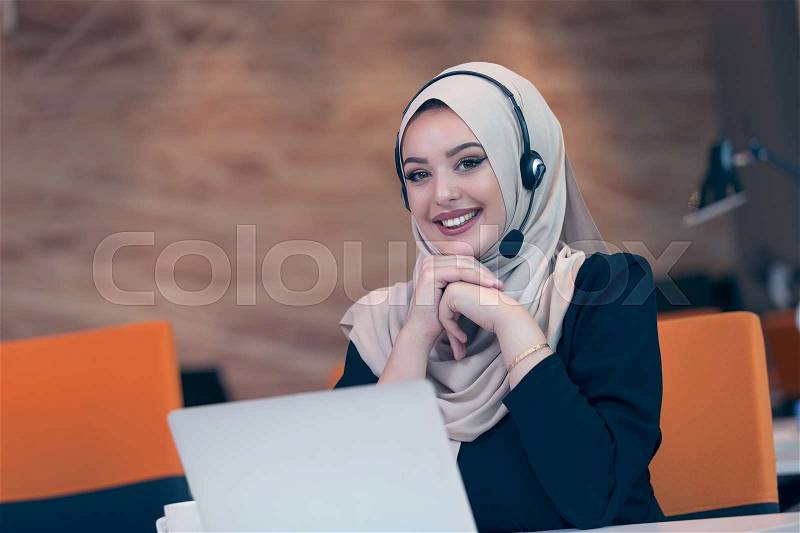 Beautiful phone operator arab woman working isolated on a white background, stock photo