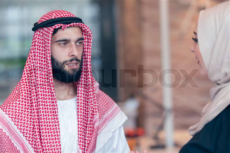 Arabic business couple working together on project at modern startup office, stock photo